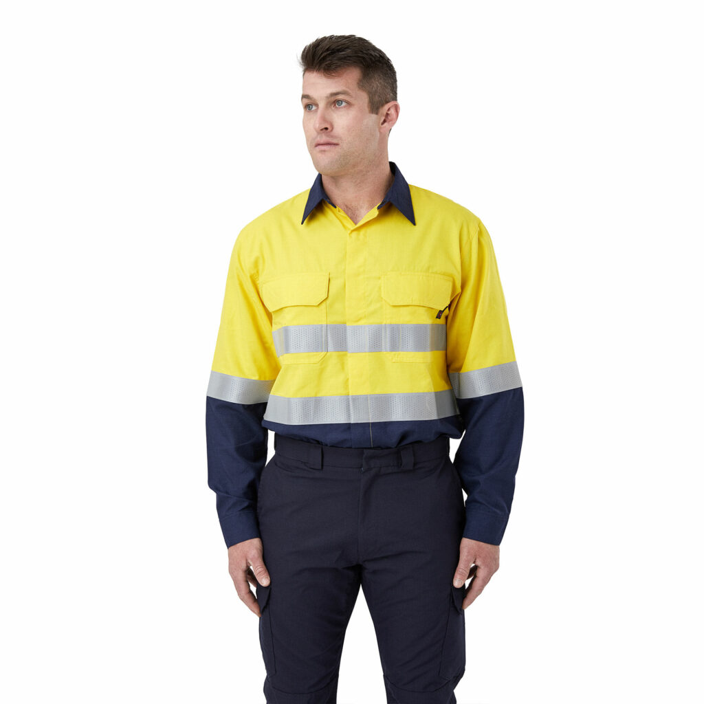 Man wearing lightweight FR yellow/navy shirt with perforated tape. Long-sleeve work shirt with reflective stripes and navy blue accents.